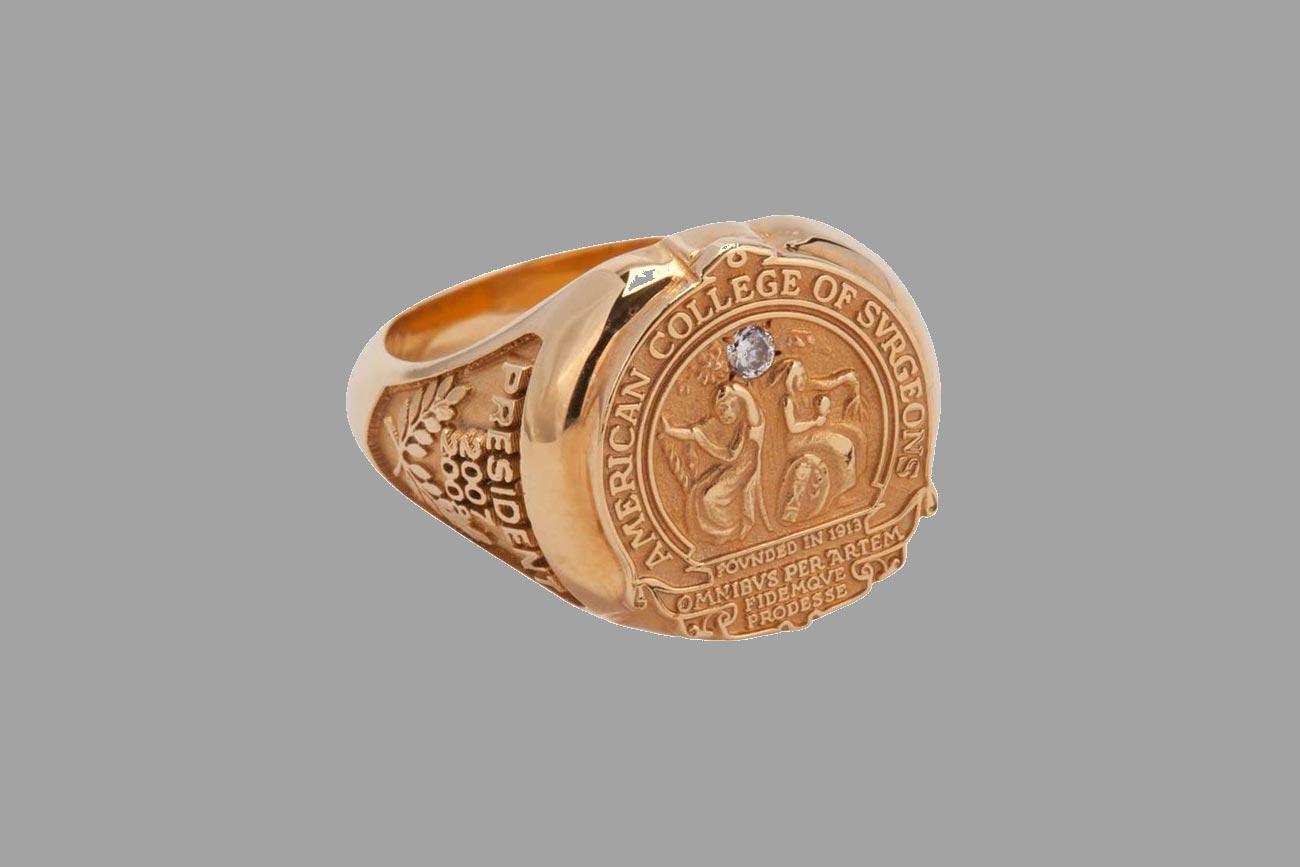  Gold ring with surgeon's college engraving and a stone.