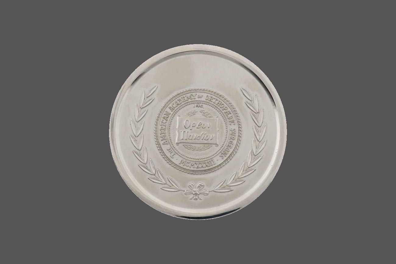 Sterling Silver disc with embossed orthopedic surgeons academy seal.